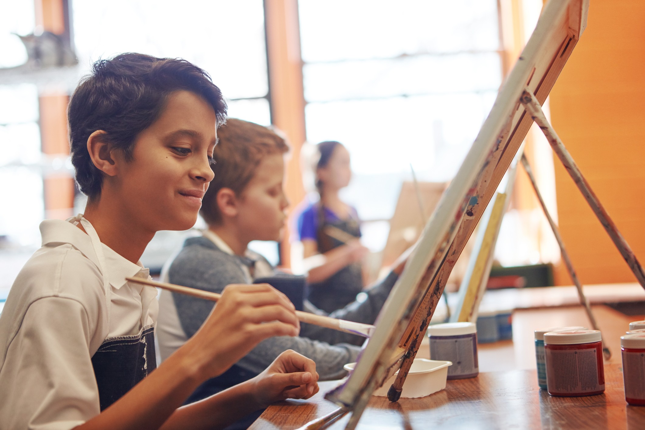 Students painting in arts class